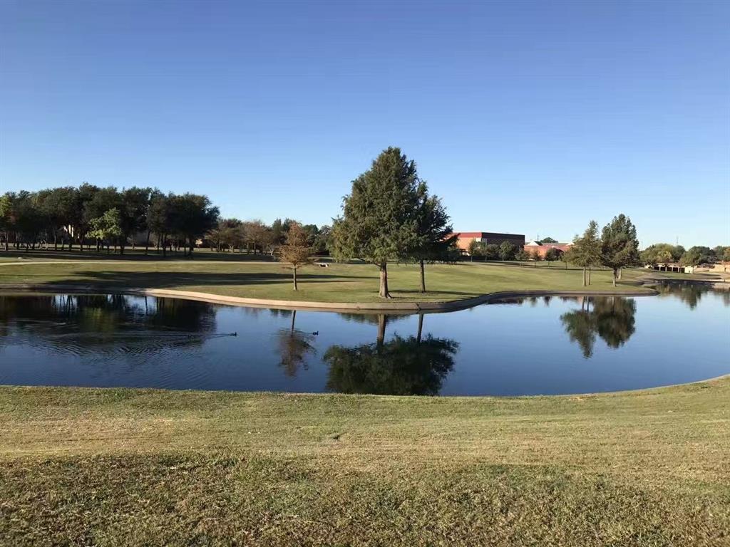 a view of a lake with houses in the back