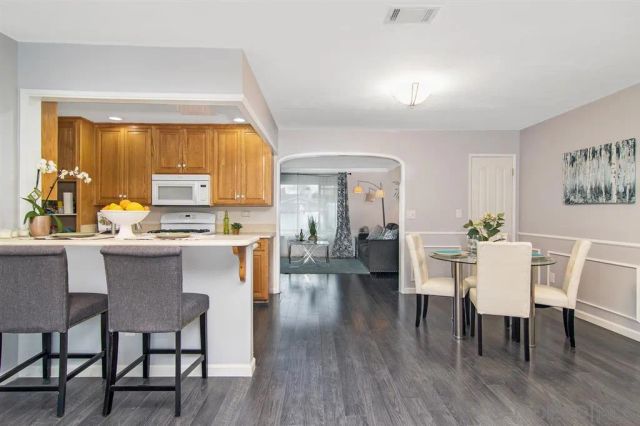 a dining room with furniture and wooden floor