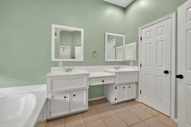 a spacious bathroom with a double vanity sink mirror and toilet