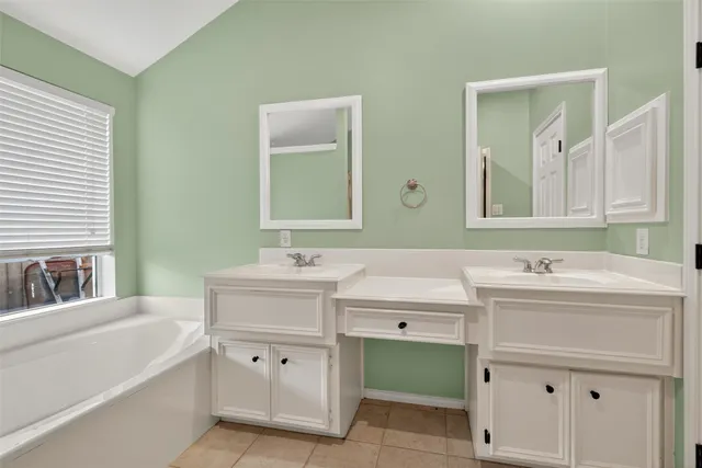a bathroom with a sink vanity and mirror