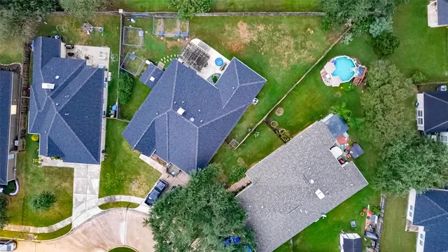an aerial view of house with pool outdoor seating and yard