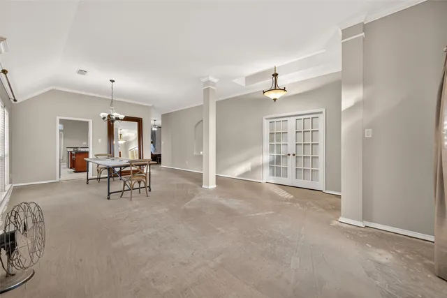 an empty room with windows and chairs