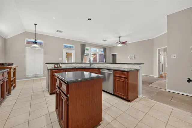 a kitchen with stainless steel appliances granite countertop a sink and a stove