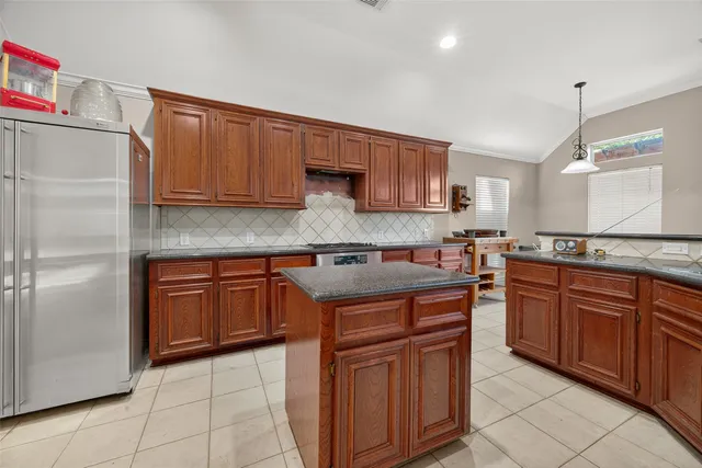 a kitchen with stainless steel appliances granite countertop wooden cabinets a sink and a stove