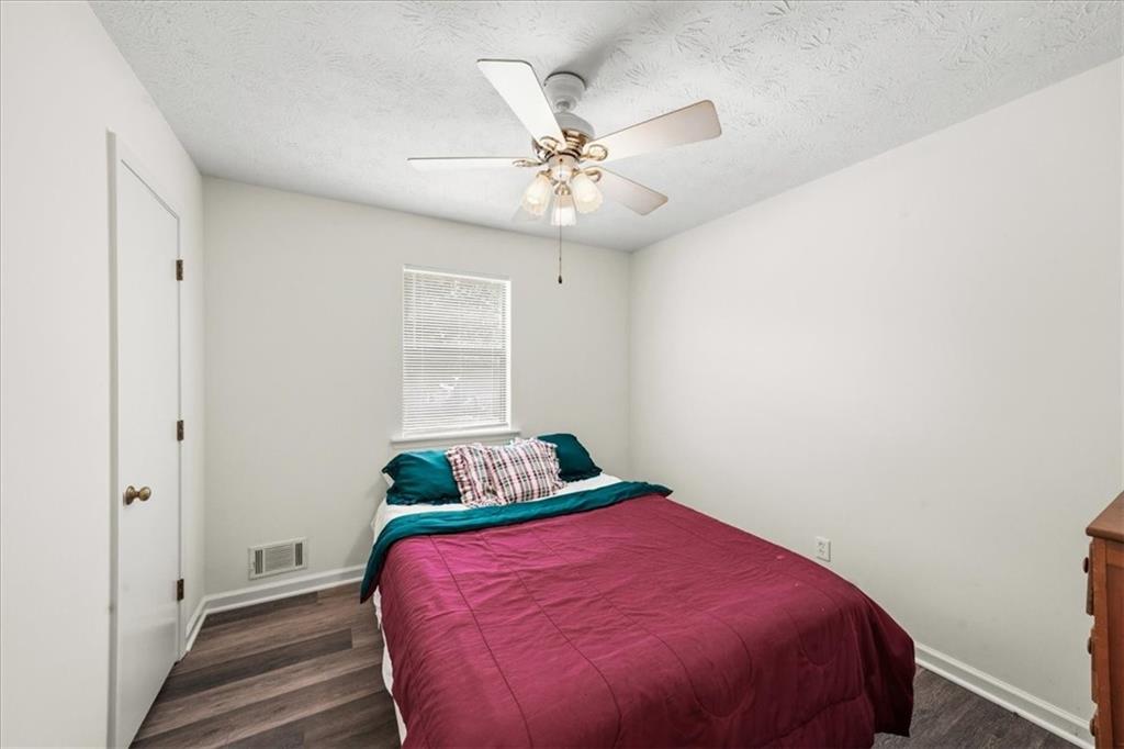 2561 Ripple Way Lawrenceville, GA 30043 - Photo 8 of 19 a bedroom with a bed and a ceiling fan