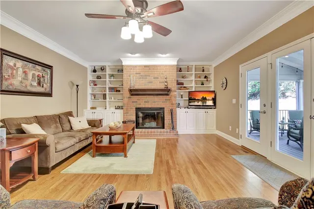 a kitchen with stainless steel appliances granite countertop a table chairs stove and wooden floor