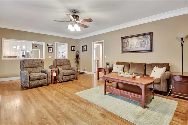 a living room with furniture kitchen view and large window