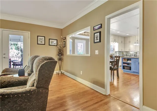 a living room with furniture a air conditioner vent and a window