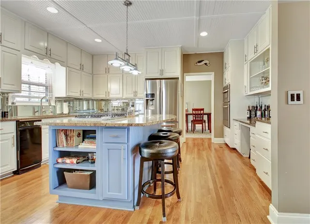 a bedroom with a large bed and a chandelier