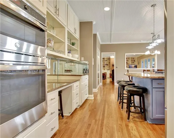 a kitchen with stainless steel appliances granite countertop a refrigerator and a stove