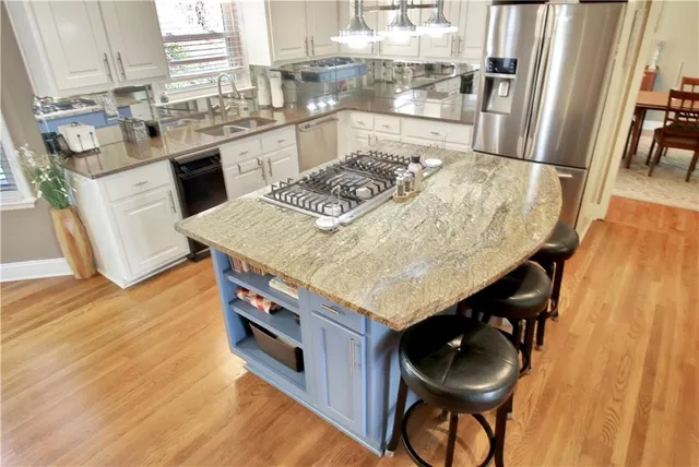a living room with furniture a flat screen tv and a chandelier