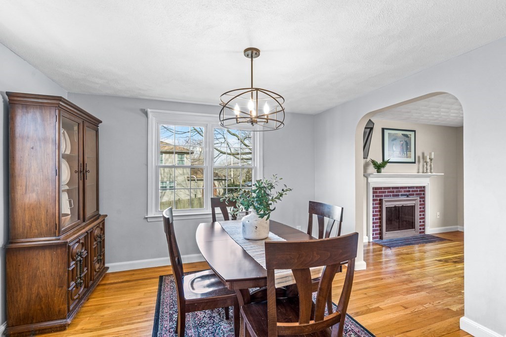 352 West Street Reading, MA 01867 - Photo 12 of 37 a dining room with furniture a chandelier and wooden floor