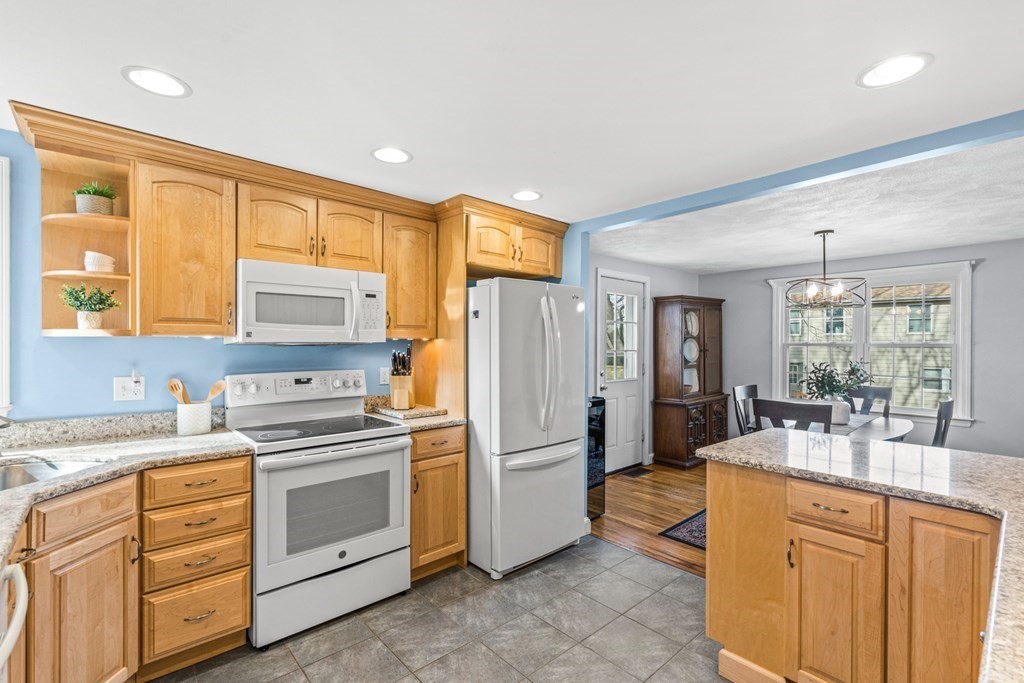 352 West Street Reading, MA 01867 - Photo 17 of 37 a kitchen with white cabinets and white appliances