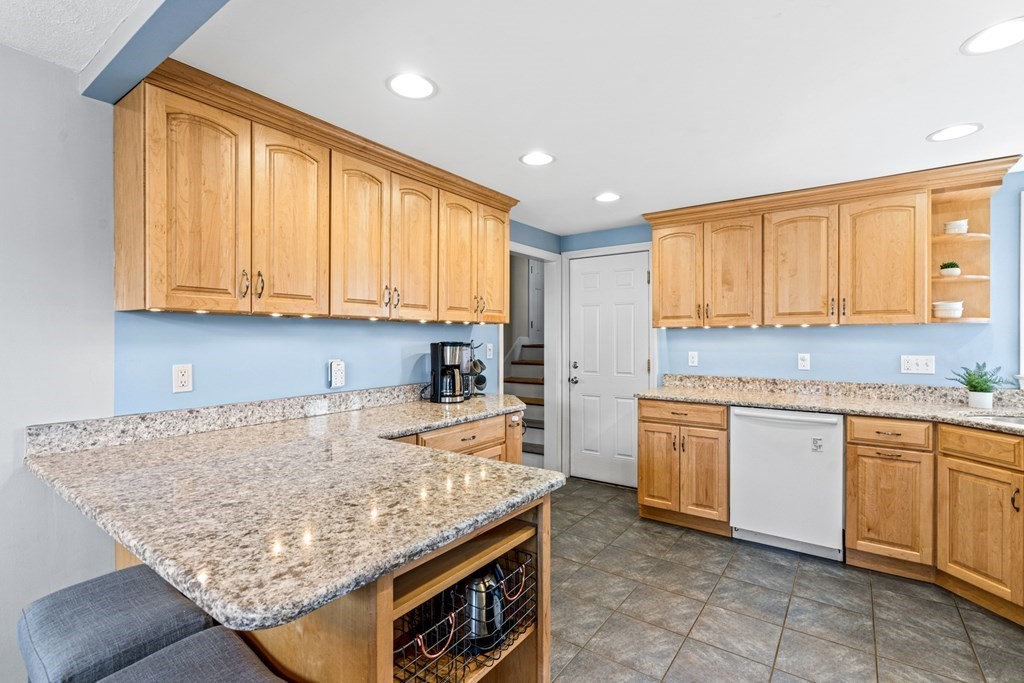352 West Street Reading, MA 01867 - Photo 19 of 37 a kitchen with granite countertop sink stove and cabinets
