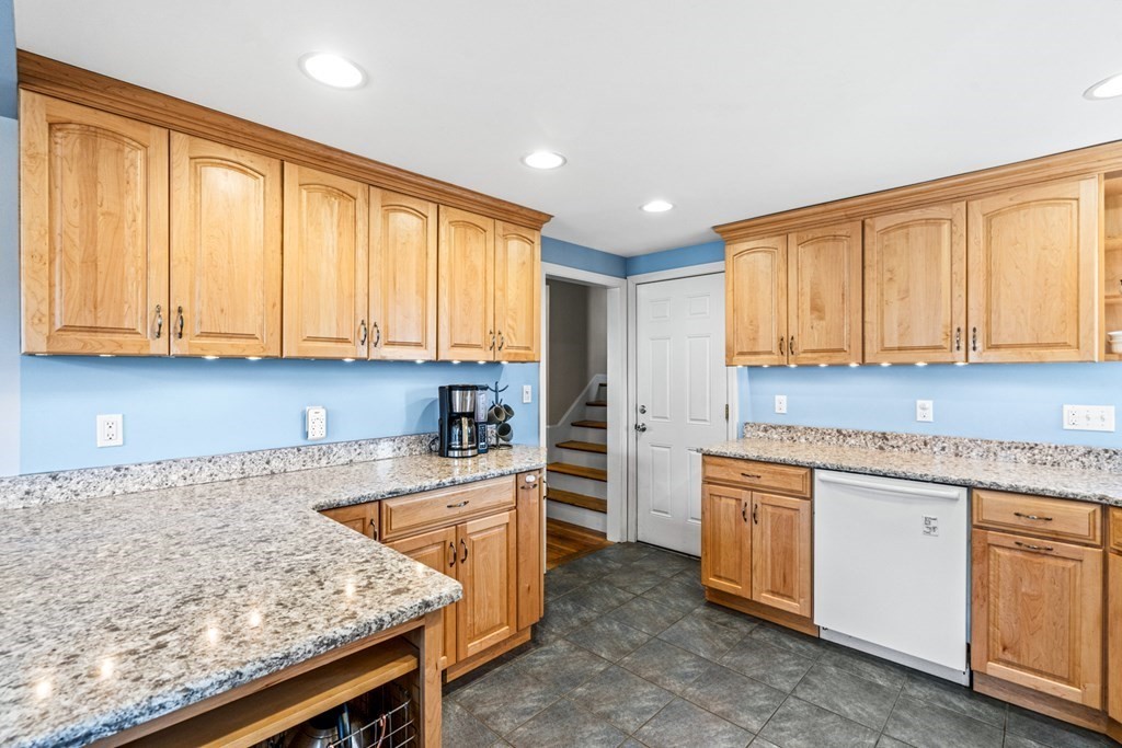 352 West Street Reading, MA 01867 - Photo 21 of 37 a kitchen with granite countertop wooden cabinets a sink and dishwasher