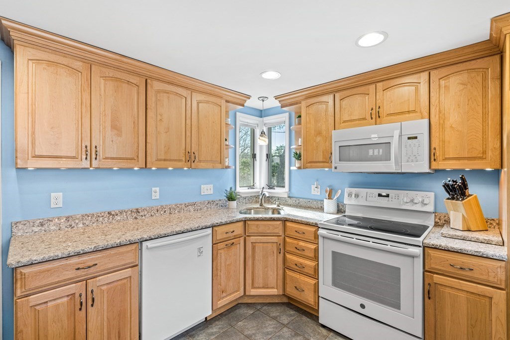 352 West Street Reading, MA 01867 - Photo 22 of 37 a kitchen with stainless steel appliances granite countertop a sink stove and cabinets