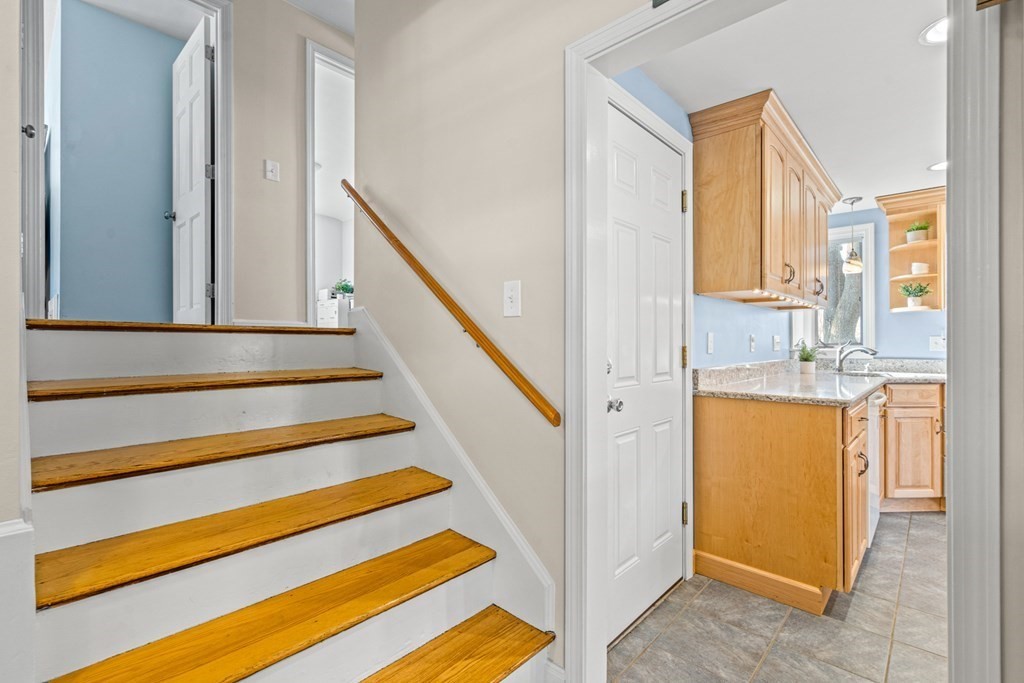 352 West Street Reading, MA 01867 - Photo 23 of 37 a view of front door with hallway and stairs