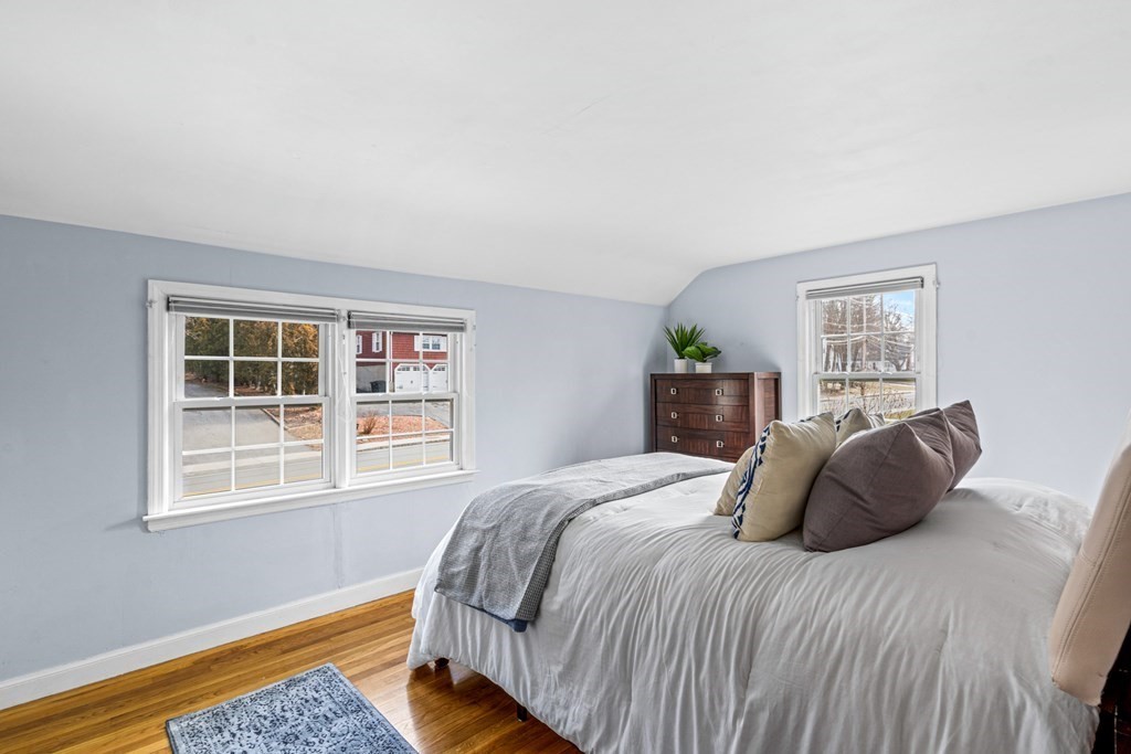 352 West Street Reading, MA 01867 - Photo 24 of 37 a bedroom with a bed and wooden floor