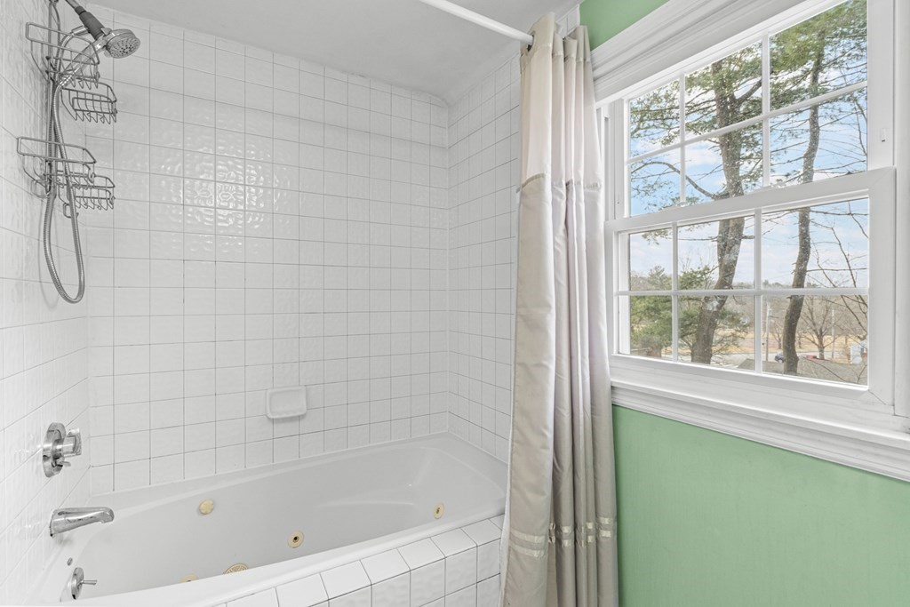 352 West Street Reading, MA 01867 - Photo 27 of 37 a bathroom with a bathtub and a shower