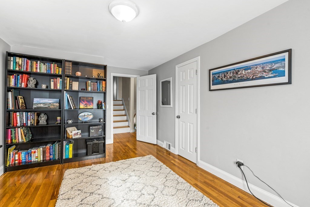 352 West Street Reading, MA 01867 - Photo 29 of 37 a bedroom with furniture and a book shelf