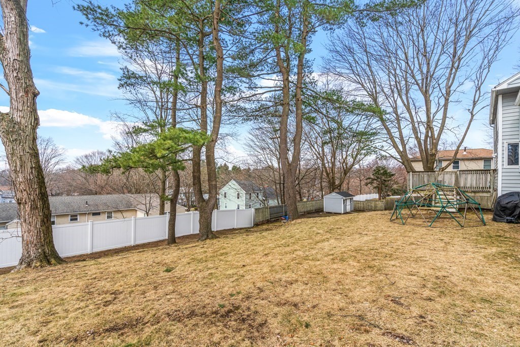 352 West Street Reading, MA 01867 - Photo 3 of 37 a view of a yard with a tree