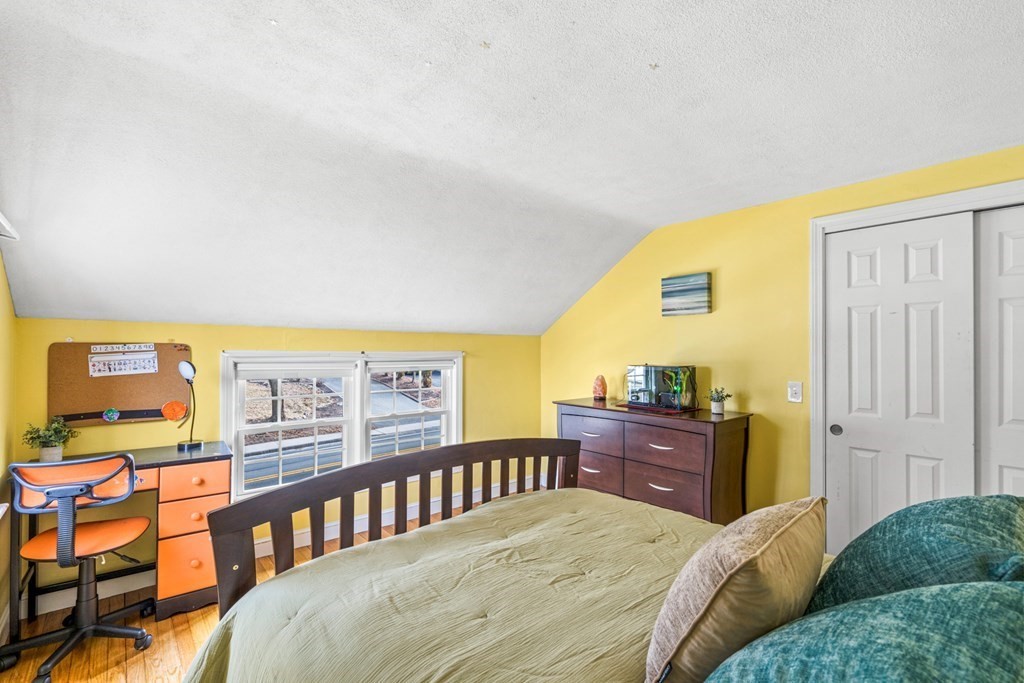 352 West Street Reading, MA 01867 - Photo 31 of 37 a bedroom with a bed and wooden floor