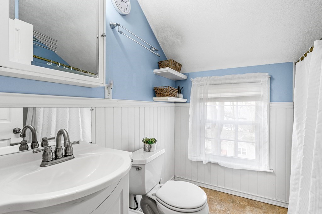 352 West Street Reading, MA 01867 - Photo 33 of 37 a bathroom with a sink a toilet and tub