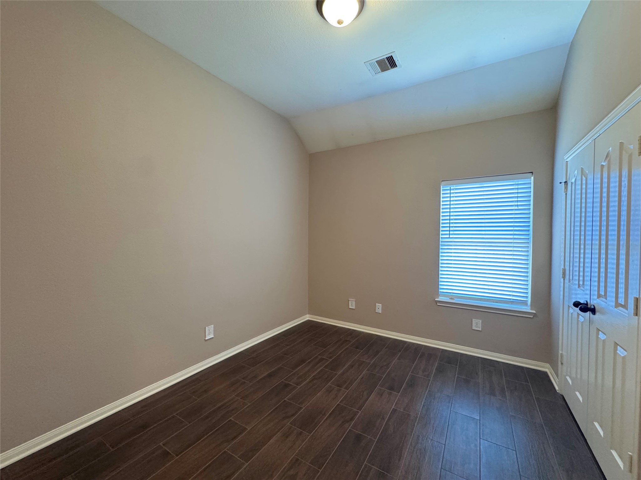 24039 Augusta Falls Lane Spring, TX 77389 - Photo 11 of 18 a view of an empty room with wooden floor and a window