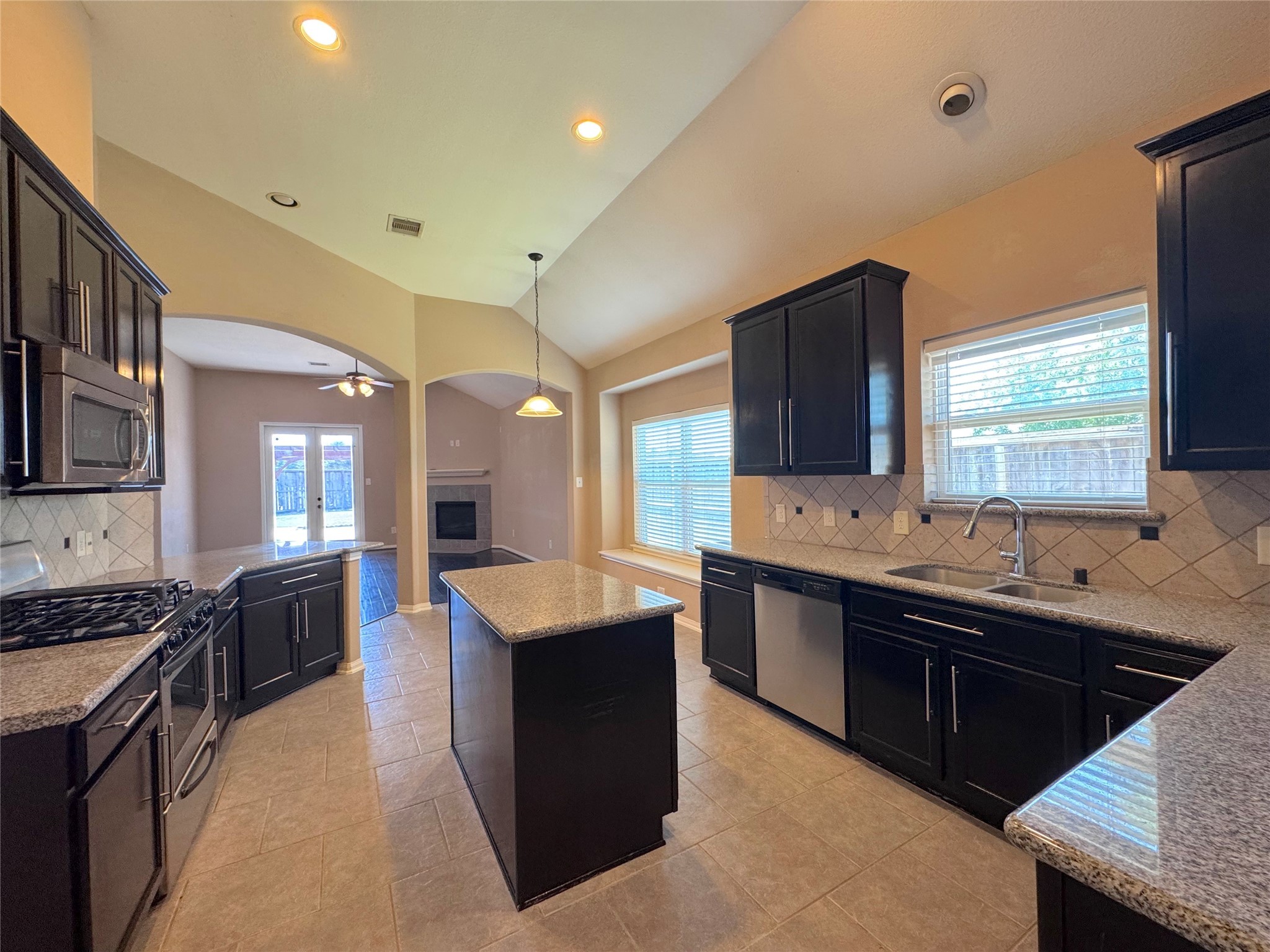 24039 Augusta Falls Lane Spring, TX 77389 - Photo 9 of 18 a large kitchen with stainless steel appliances granite countertop a sink and a stove
