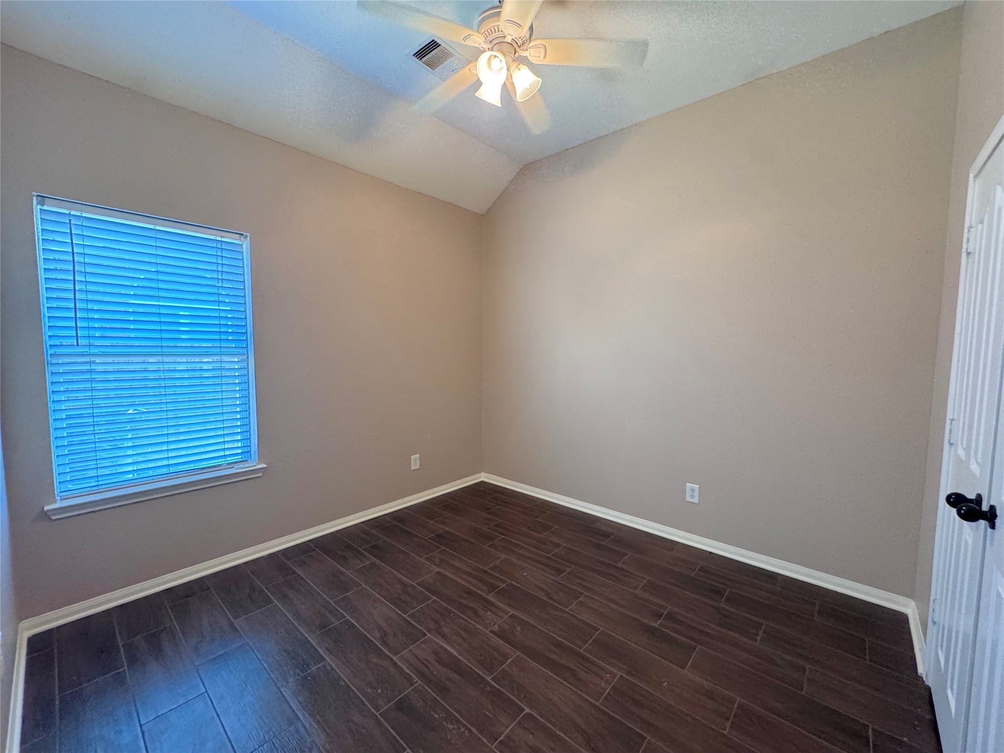 24039 Augusta Falls Lane Spring, TX 77389 - Photo 10 of 18 an empty room with wooden floor and windows