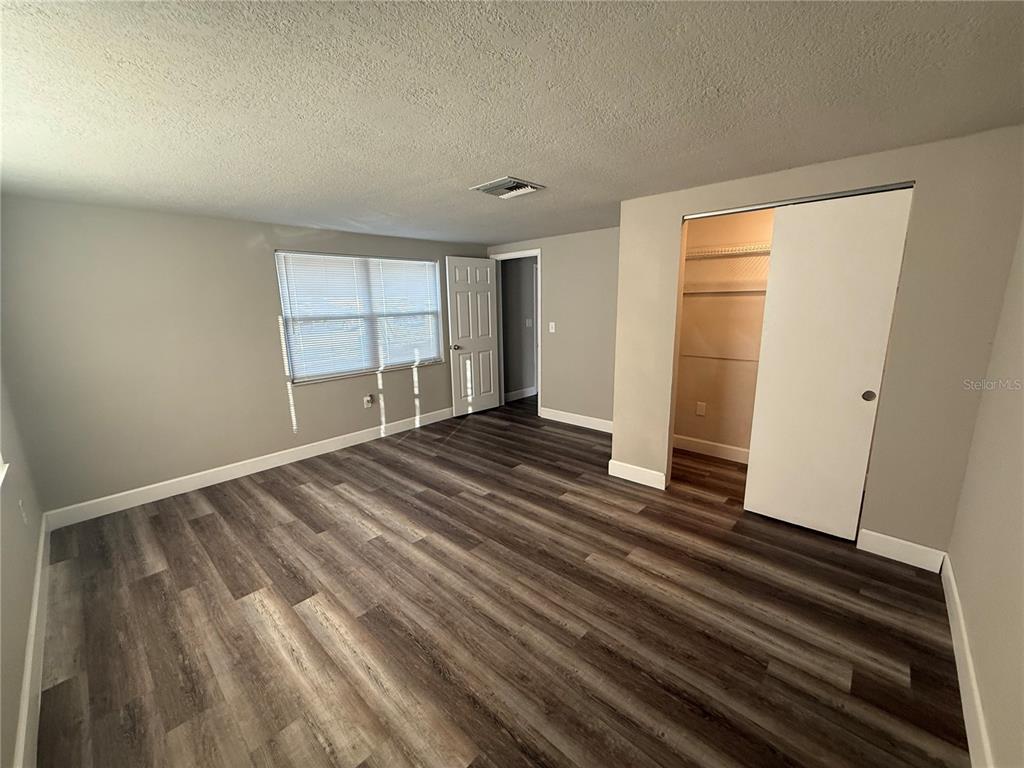 7104 Ingleside Drive Port Richey, FL 34668 - Photo 7 of 14 a view of empty room with wooden floor and fan