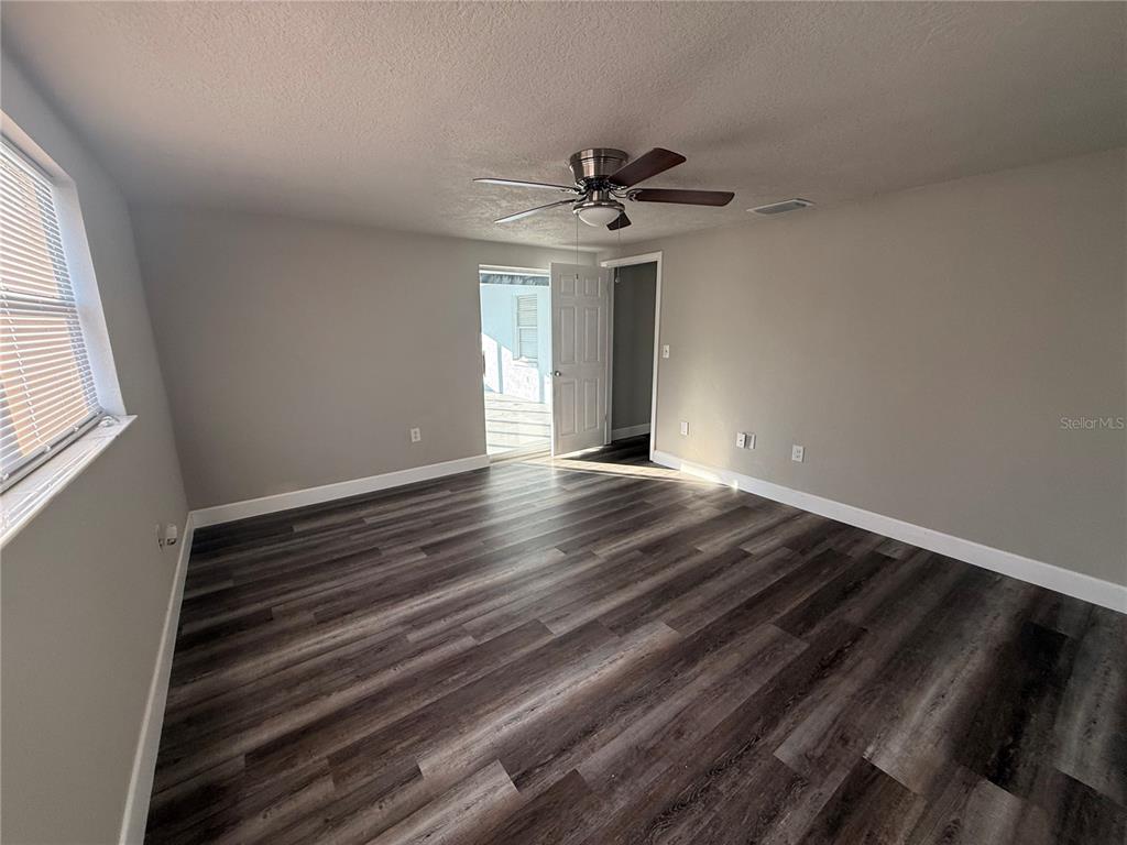 7104 Ingleside Drive Port Richey, FL 34668 - Photo 10 of 14 a view of an empty room with window and wooden floor