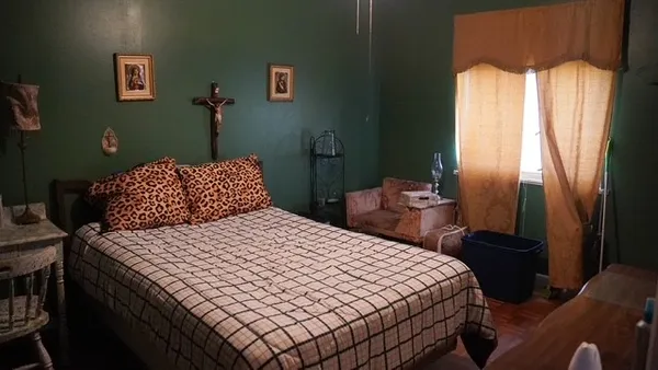 a bedroom with a bed and a chandelier