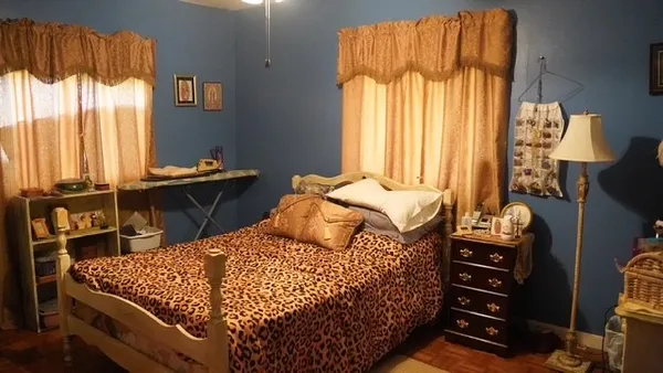 a bedroom with a bed and a window