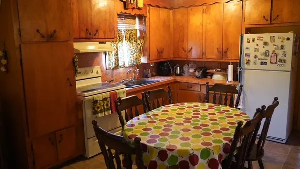 a kitchen with stainless steel appliances kitchen island granite countertop a sink and cabinets