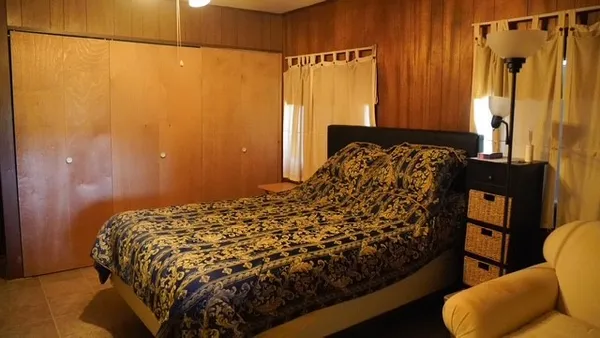 a bed sitting in a bathroom next to a window