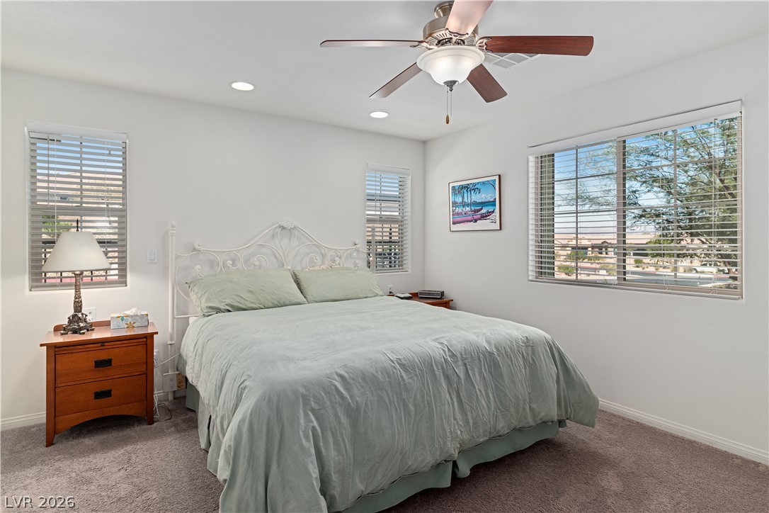 2269 Chandler Ranch Place Laughlin, NV 89029 - Photo 19 of 96 Carpeted Primary bedroom with multiple windows, recessed lighting, and a ceiling fan