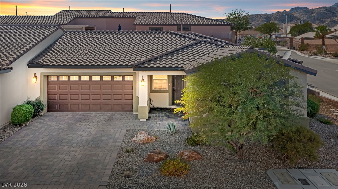 2269 Chandler Ranch Place Laughlin, NV 89029 - Photo 2 of 96 Mediterranean / spanish-style home with a tiled roof, stucco siding, decorative driveway, and a garage