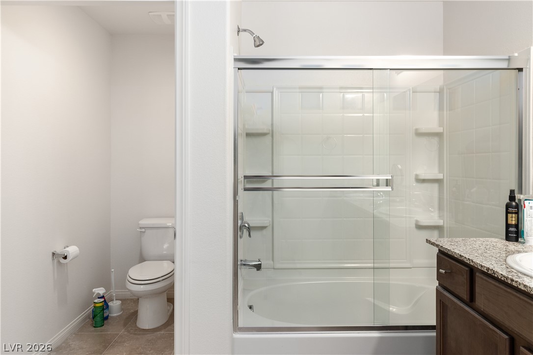 2269 Chandler Ranch Place Laughlin, NV 89029 - Photo 27 of 96 Primary Bathroom with bath / shower combo with glass door, vanity, and light tile patterned floors