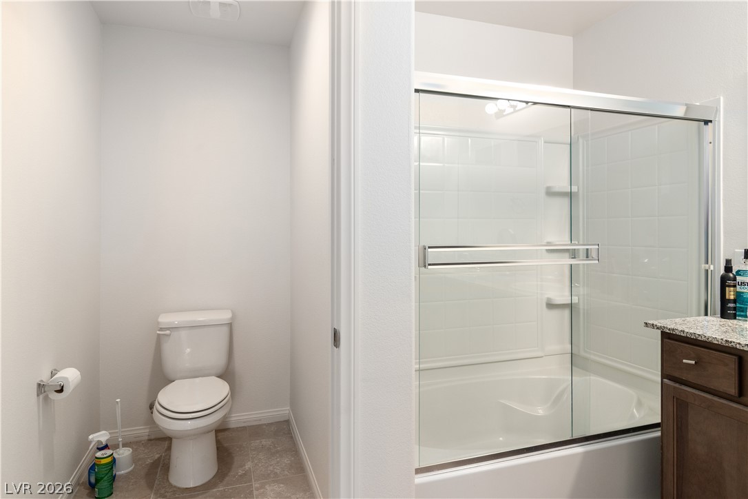 2269 Chandler Ranch Place Laughlin, NV 89029 - Photo 28 of 96 Full Primary bath featuring light tile patterned floors, bath / shower combo with glass door, and vanity