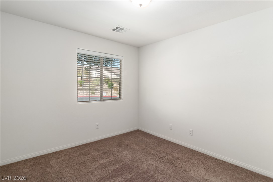 2269 Chandler Ranch Place Laughlin, NV 89029 - Photo 37 of 96 Bedroom with dark colored carpet and baseboards