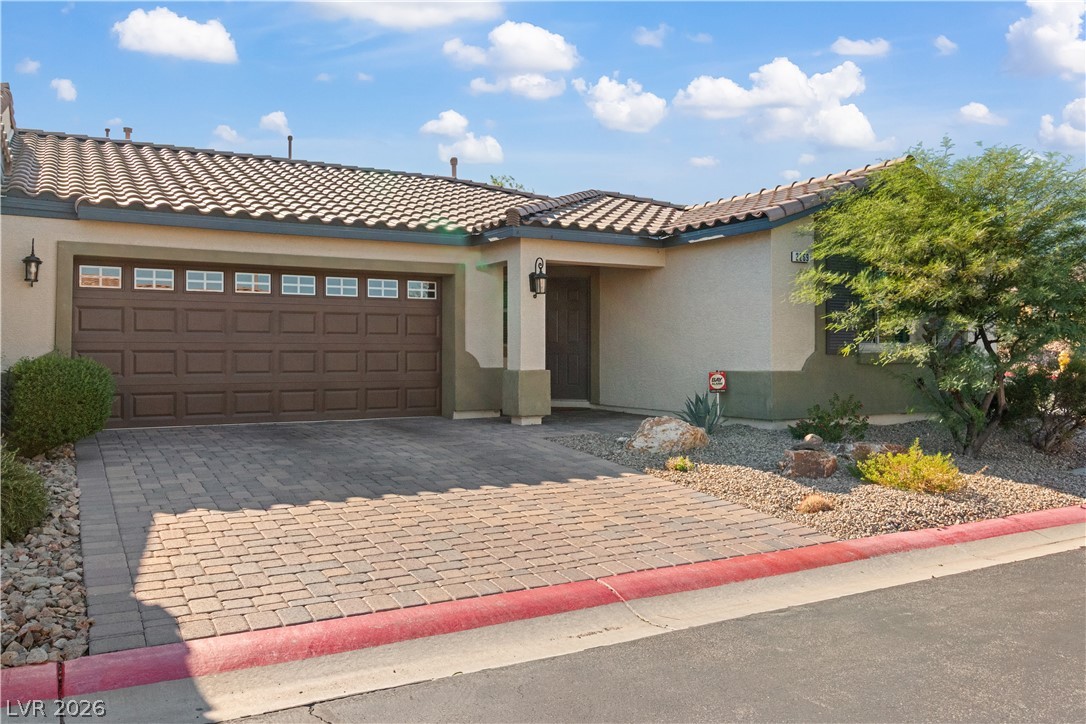 2269 Chandler Ranch Place Laughlin, NV 89029 - Photo 55 of 96 Mediterranean / spanish-style house featuring stucco siding, decorative driveway, a garage, and a tile roof