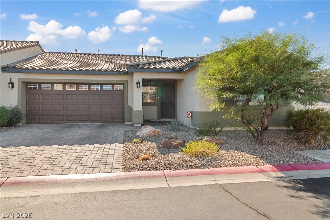 2269 Chandler Ranch Place Laughlin, NV 89029 - Photo 56 of 96 View of front of home with stucco siding, decorative driveway, a tile roof, and a garage