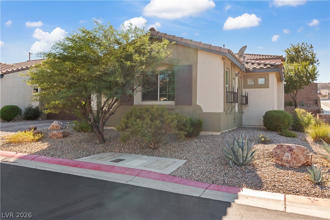 2269 Chandler Ranch Place Laughlin, NV 89029 - Photo 58 of 96 View of side of home with stucco siding and a tile roof