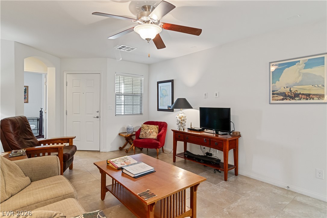 2269 Chandler Ranch Place Laughlin, NV 89029 - Photo 6 of 96 Living area featuring ceiling fan, arched walkways, and light tile patterned floors
