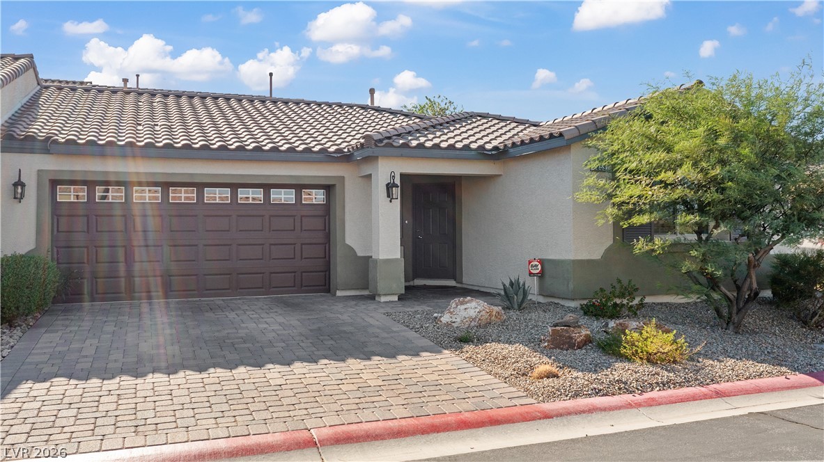 2269 Chandler Ranch Place Laughlin, NV 89029 - Photo 63 of 96 Mediterranean / spanish-style house with stucco siding, decorative driveway, an attached garage, and a tile roof