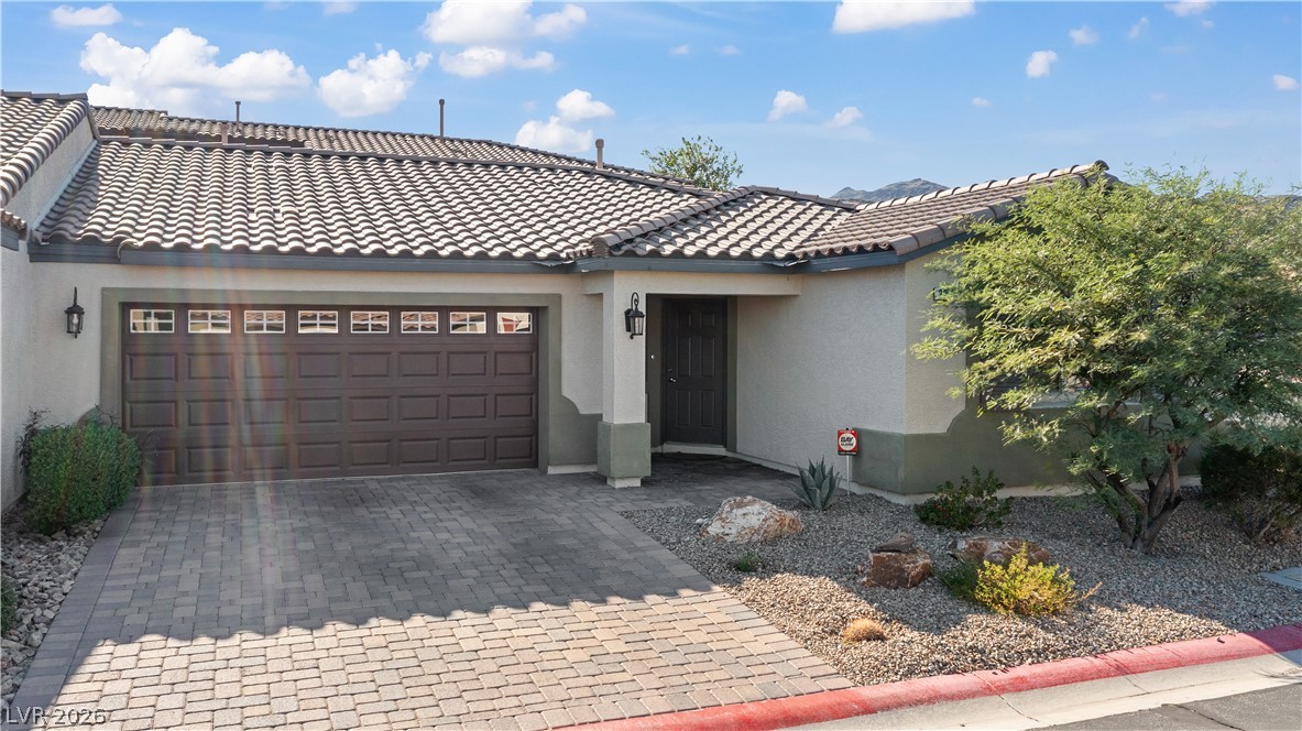 2269 Chandler Ranch Place Laughlin, NV 89029 - Photo 64 of 96 Mediterranean / spanish house featuring stucco siding, decorative driveway, and a garage
