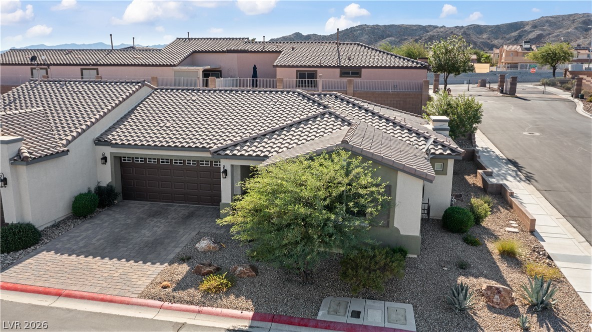 2269 Chandler Ranch Place Laughlin, NV 89029 - Photo 66 of 96 View of front facade with stucco siding, a tile roof, and a mountain view