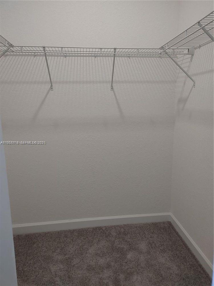 13313 Southwest 287th Terrace Homestead, FL 33033 - Photo 6 of 26 a view of a room with racks on the wall