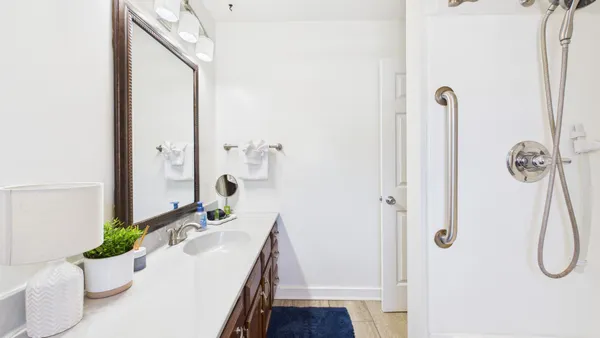 a bathroom with a sink vanity mirror and toilet